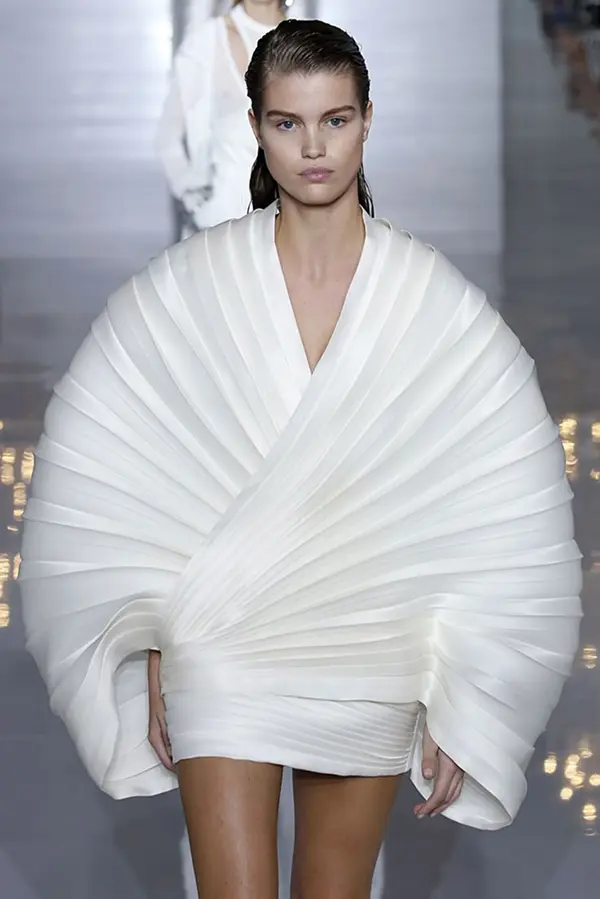femme avec courte robe blanche volumineuse et plissée